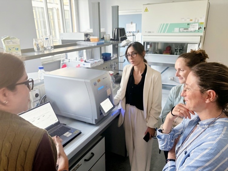 Four people are in a laboratory.